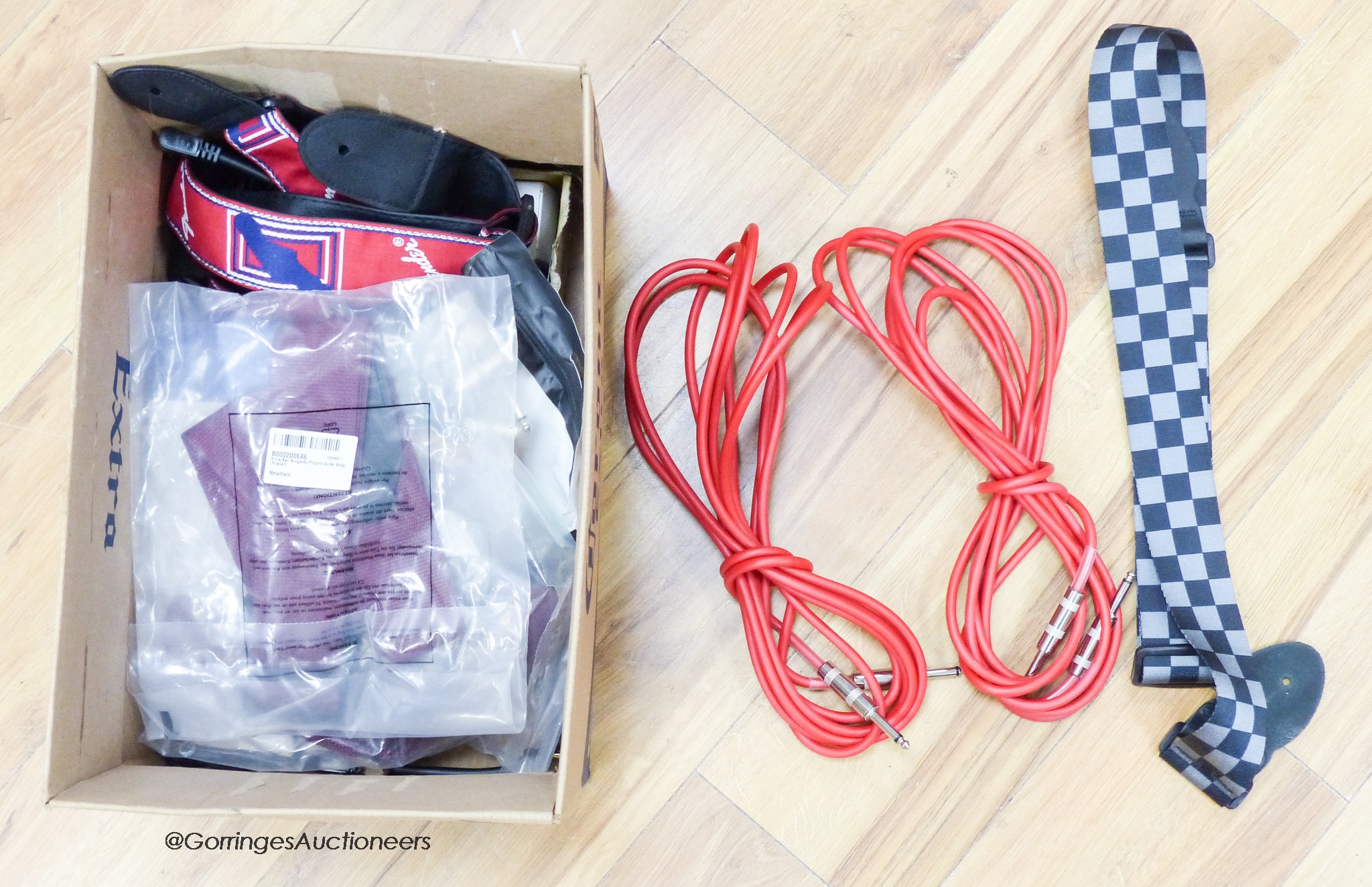 A quantity of guitar leads, straps, picks etc